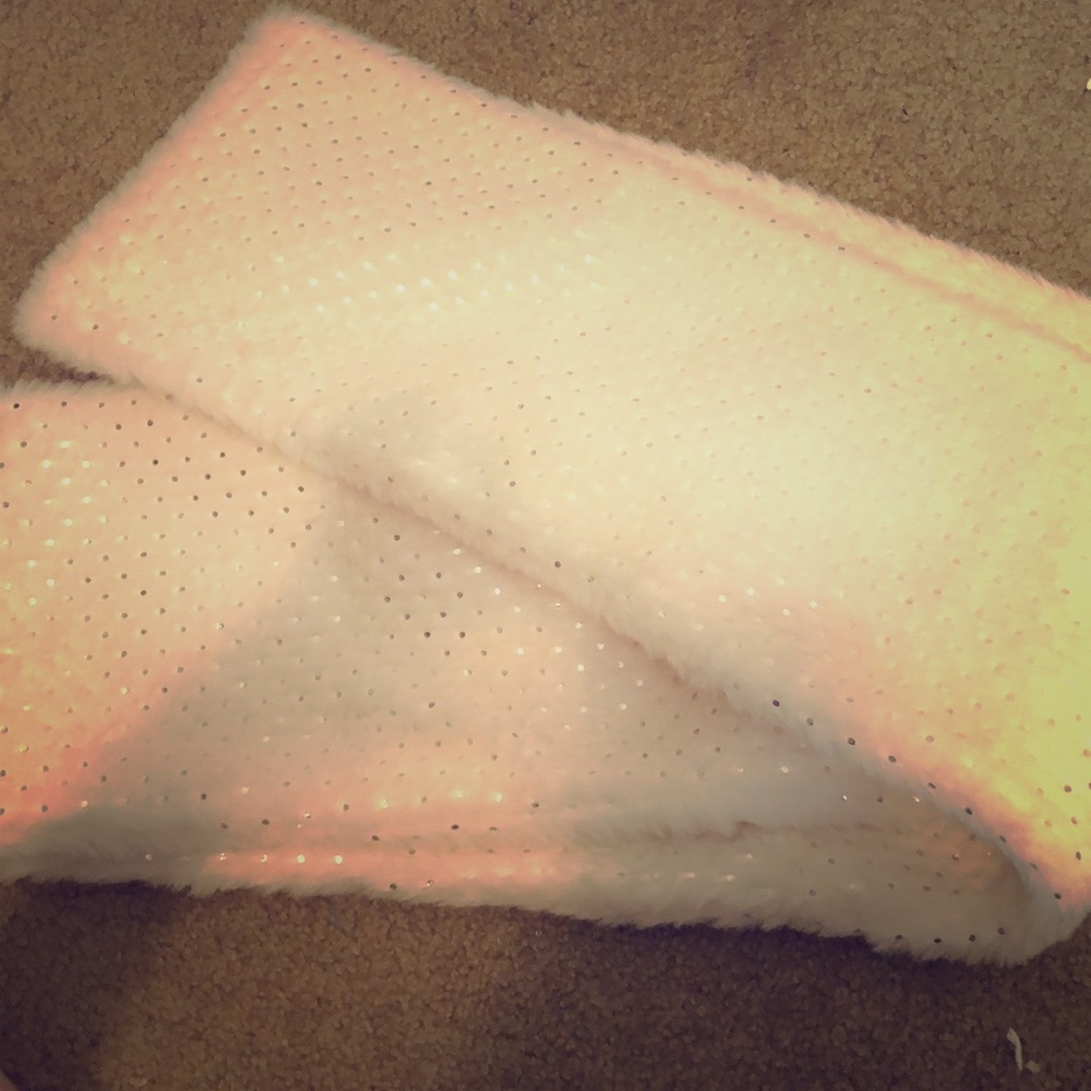 This is a faux fur scarf that has silver dots.